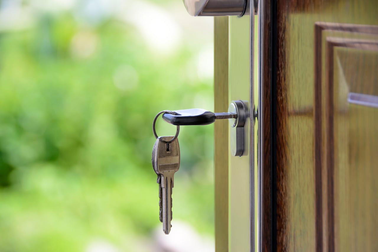 Mastering the First Impression: Your intriguing post title goes here Key inserted in door lock against a blurred green background, symbolizing security and real estate.